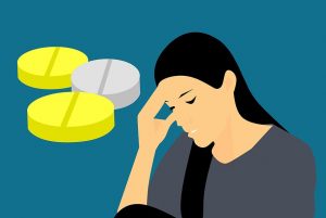 illustration of a person with pills and a headache
