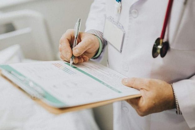doctor writing down notes